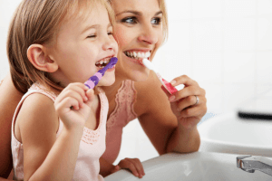 mother force children to brush teeth